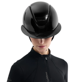 Person wearing a black riding helmet with 'LeMieux' branding on a white background