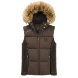 Holland Cooper Cranborne Training Gilet Variant Chocolate. A dark brown puffer vest with a large tan faux-fur trimmed hood, featuring a front zipper, ribbed knit sleeves, and a tonal embroidered crest logo on the left chest.