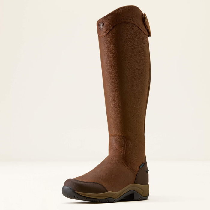 A single knee-high riding boot in brown leather, shown from a side profile against a clean, off-white studio background.