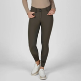Pikeur AW26 Ceelina Matrixgriptex Breeches Variant Deep Khaki. A model wearing dark olive green riding breeches with a beige long-sleeve top and white sneakers, shown from the waist down against a light gray studio background.