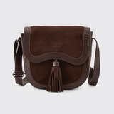 Dubarry Of Ireland Monart Bag Variant Cigar. A dark brown suede and leather crossbody bag with a tassel detail and a small 'DUBARRY' logo on the front, set against a light gray background.