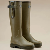 Le Chameau Ladies Vierzonord Neoprene Lined Wellies Variant Iconic Green. A pair of tall olive green rubber rain boots with a buckle strap on the outer side and a small oval metal logo badge near the top, shown on a plain beige studio background.