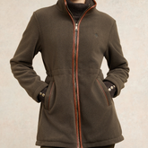 Holland Cooper Country Longline Fleece Varient Khaki. A dark brown fleece jacket with a full front zipper, contrasted with a thin orange-brown trim, worn by a model. The jacket features a stand-up collar, zippered hand pockets, and a small embroidered logo on the left chest.