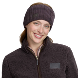 Lady wearing a brown headband with a matching brown fleece jacket against a white background.