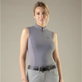 Model wearing sleeveless gray top on beige background
