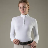 Woman wearing a white long-sleeve top against a gray background