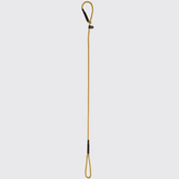 Gold rope dog lead with brown leather detailing on a white background.