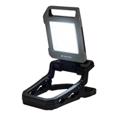 A portable LED work light with a black and gray rugged frame, shown in its open, folded-down clamp position on a solid white background.