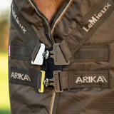 LeMieux AW26 Arika Ripstop 0g Turnout Rug Varient Alpine. Close-up of a brown/green rug with black straps and silver metal buckles, featuring the brands 'LeMieux' and 'ARIKA' embroidered on the straps.