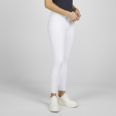 Model wearing white riding pants with trainers on faded back ground