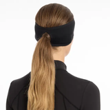 LeMieux AW26 Ear Warmer Headband Variant Colour Black.
A woman in profile wearing a black athletic headband showing pony tail through a gap in the headband, paired with a black athletic top against a plain white background.