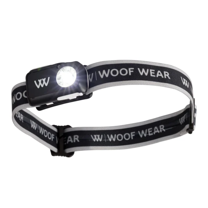 A black and gray adjustable headlamp with a bright white LED light, featuring the Woof Wear logo printed repeatedly on the elastic band.