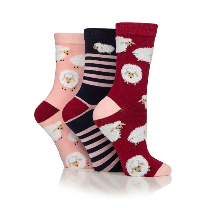 Three pairs of socks with sheep pattern on a white background
