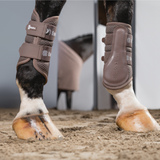 A photo of two horses legs wearing brown boots with 'Eskadron' branding.