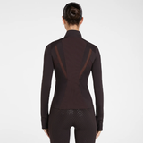 Aztec Diamond AW26 Core Fitted Jacket Variant Espresso. A woman viewed from the back wearing a dark brown long-sleeve athletic top with sheer mesh side panels and matching dark perforated leggings, against a light grey studio background.
