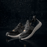 Black training shoes against a dark backgriound