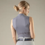 Model wearing sleeveless gray top on beige background