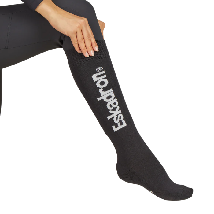 Black sock with 'Eskadron' logo worn by a person on a white background