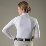 Woman wearing a white long-sleeve shirt with mesh sleeves against a neutral background