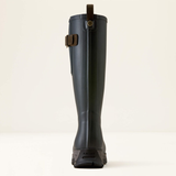 Back of a Navy rubber boot with Brown detailing against a beige background.