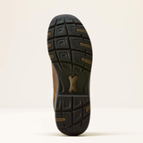 Ariat Men's Terrain Trek H20 Variant Dark Chocolate. The outsole of a hiking boot is shown from a top-down view against a clean, off-white background. The sole is predominantly black with a textured tread pattern and a central metallic bronze logo plate.