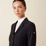 Woman wearing black blazer and white shirt on beige background
