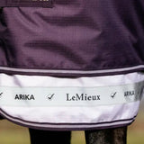 Close-up of a horse rug with Arika and LeMieux labels on a blurred background