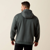 A man viewed from the back wearing a dark gray pullover hoodie with a relaxed fit, set against a plain light beige studio background.