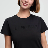 Person wearing a black t-shirt with 'LEMIEUX' branding on a plain background