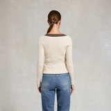 Person wearing cream jumper and jeans