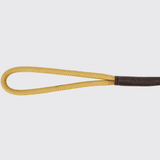 A close-up of a braided yellow loop strap with dark brown leather detailing featuring the embossed brand name 'Dubarry'.