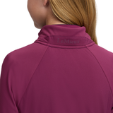LeMieux AW26 Young Rider Betty Lightweight Jacket Varient Blackberry. Close-up back view of a woman wearing a LeMieux athletic quarter-zip pullover in a deep berry purple color, showing the brand name on the inner collar.