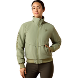 Ariat Women's Stable 2.0 Insulated Jacket Varient Oil Green. Woman wearing a olive bomber coat and black trousers on a white background.