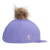 Purple riding hat with a fur pom-pom on a white background