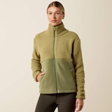 Ariat Ladies Laviolette Full Zip Jacket Variant Oil Green. A woman modeling a fleece zip-up jacket with a colorblock design, featuring a textured khaki upper section and a solid olive green lower panel, set against a plain beige background.