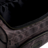 Close-up of a dark brown textured nylon bag with black zippers and a black interior, featuring a gold-bordered 'LE MIEUX' brand patch on the front.