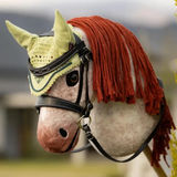 Toy horse wearing a decorative headstall with a green hood and red fringe.