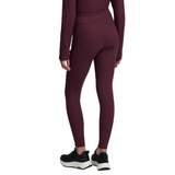 LeMieux AW26 Young Rider Orla Ribbed Pull Ons Varient Bramble. A model from the back wearing high-waisted, long-sleeve athletic leggings in a deep burgundy color with a subtle grid texture, paired with black and white sneakers against a solid white background.