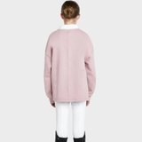 Back of person wearing a pink sweater and white trousers on a light grey background