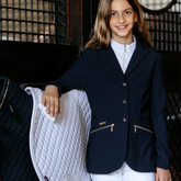 Child in navy jacket on faded stable background