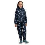 LeMieux AW26 Mini Pippin Splash Jacket Varient Navy. A young girl stands against a white background wearing a matching hooded jacket and jogger pants set in navy blue with a white animal print, paired with teal sneakers.