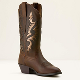 Brown cowboy boot with decorative patterns on a beige background