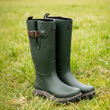 Green rubber boots with a buckle on grass