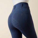 Close-up of grip pattern on blue riding tights against a beige background.