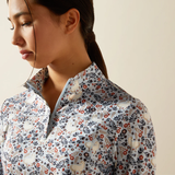 Woman wearing a floral patterned shirt against a beige background