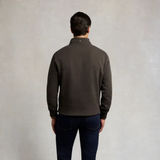 Holland Cooper Classic Quarter Zip Sweat (Men's) Variant Colour Bournville. A male model wearing a grey coloured sweater and blue jeans on grey background.