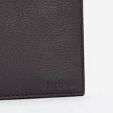 Close-up of a dark leather wallet with 'Barbour' branding on a light grey background