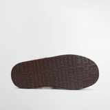 Brown shoe sole with Barbour brand logo on a light grey background