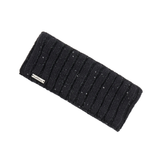 LeMieux AW26 Bernie Sequin Headband Variant Colour Black.
A black ribbed knit ear warmer headband with subtle silver glitter flecks, featuring a small white brand label that reads 'Le Mieux'.