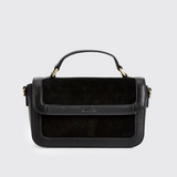 black leather and suede boxy handbag against a grey background